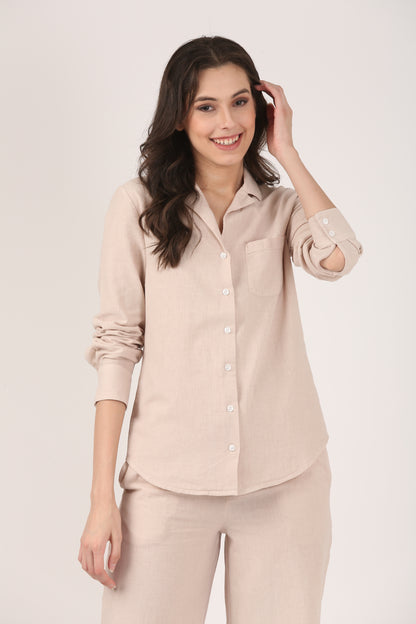 Model wearing a dusty pink linen-cotton button-down shirt with lapel collar and chest pocket, paired with matching wide-leg pants as a relaxed co-ord set.