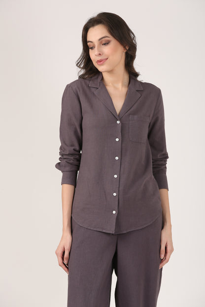 Woman wearing a charcoal grey linen shirt with lapel collar, paired with matching linen flare pants, styled as a minimalist co-ord set.